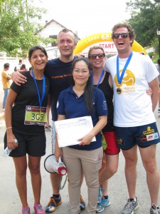 Friends runners (from left) Kanchan, Steinunn and Allan with Laos Country Program Director Ket and event organizer Michael.
